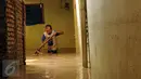 Seorang warga membersihkan sisa lumpur di Rawajati, Kalibata, Jakarta, Senin (16/11/2015).Hujan deras yang melanda Bogor, Minggu (15/11) mengakibatkan puluhan rumah warga di bantaran sungai Ciliwung terendam. (Liputan6.com/Helmi Fithriansyah)