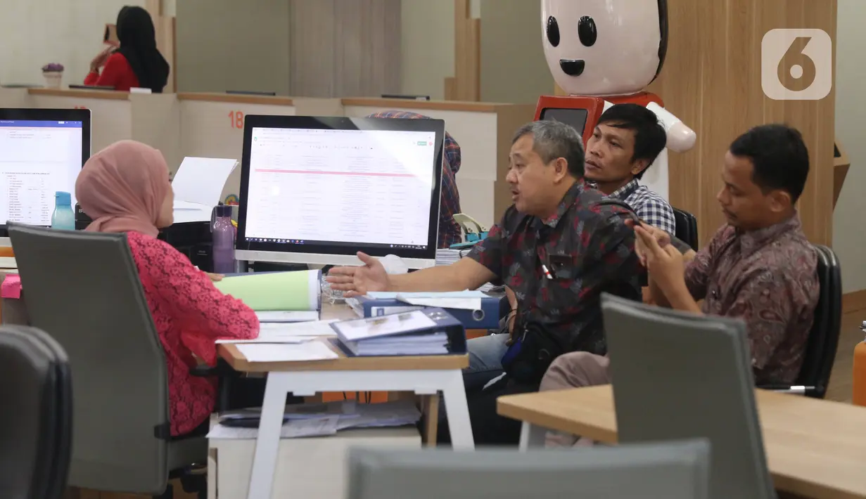 Petugas melayani seorang pemohon perizinan di Mal Pelayanan Publik, Jakarta, Jumat (6/3/2020). Mal Pelayanan Publik Provinsi DKI Jakarta  meningkatkan tindakan pencegahan penyebaran virus corona dan memastikan seluruh tempat pelayanan publik yang bersih dan aman. (Liputan6.com/Angga Yuniar)