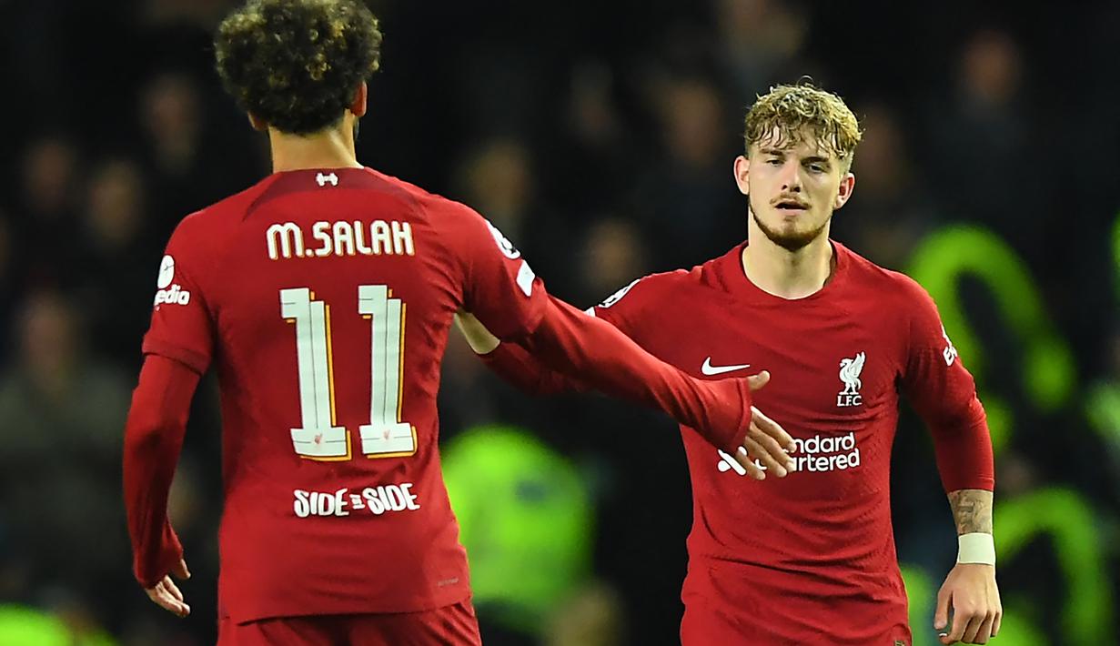 Selebrasi gelandang Liverpool, Harvey Elliott (kanan) bersama Mohamed Salah setelah mencetak gol ke gawang Glasgow Rangers pada laga matchday keempat Grup G Liga Champions 2022/2023 di Ibrox Stadium, Glasgow (12/10/2022). Harvey Elliott mencetak gol tersebut dalam usia 19 tahun, 6 bulan dan 8 hari. Ia total bermain dalam 8 laga di Liga Champions 2022/2023 bersama Liverpool dengan torehan 2 gol. (AFP/Andy Buchanan)