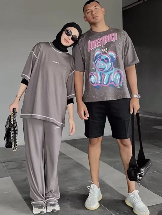 <p>Aghnia tampil dengan oversize kaos one set warna cokelat. Ia memadukannya menggunakan celana hitam yang serasi dengan kerudung, manset, kacamata, hingga tasnya.&nbsp;credit (@emyaghnia)</p>