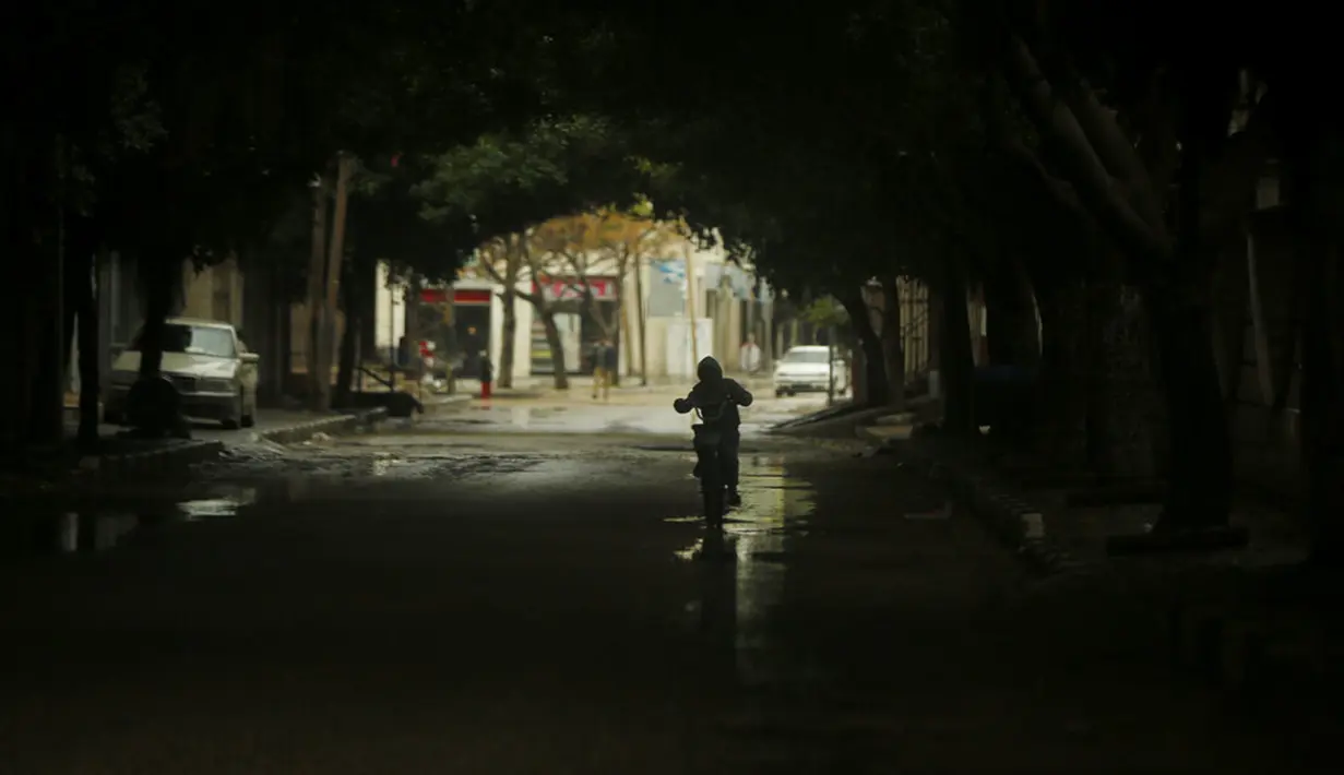 Seorang anak mengendarai sepedanya saat cuaca dingin di Kota Gaza, Palestina, 27 Januari 2022. (AP Photo/Hatem Moussa)