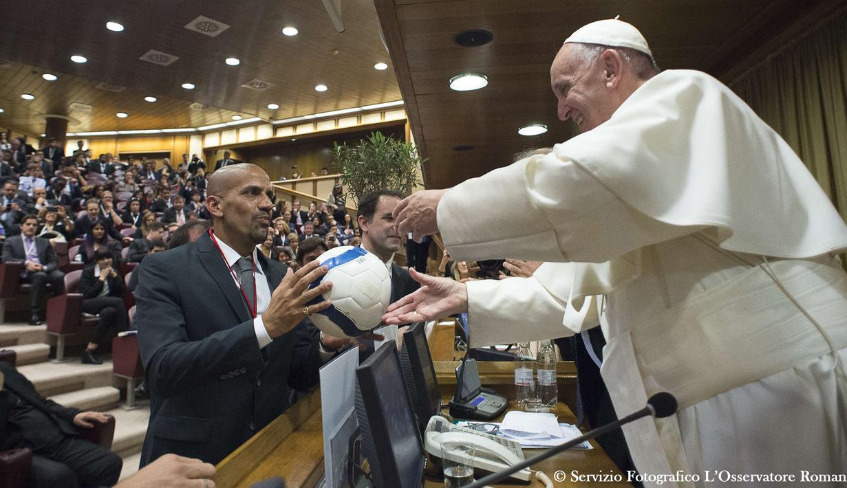 Mantan pesepak bola Argentina, Juan Sebastian Veron memberikan bola kepada Paus Fransiskus dalam pertemuan dengan para peserta Kongres Dunia Keenam Yayasan Kepausan Scholas Occurrentes, pada tanggal 29 Mei 2016 di Vatikan. Scholas adalah organisasi internasional hak kepausan yang disetujui dan dibentuk oleh Paus Fransiskus di Kota Vatikan pada tanggal 13 Agustus 2013. Organisasi ini menggabungkan teknologi dengan seni dan olahraga untuk mempromosikan integrasi sosial dan budaya perjumpaan demi perdamaian.  (AFP/Osservatore Romano)