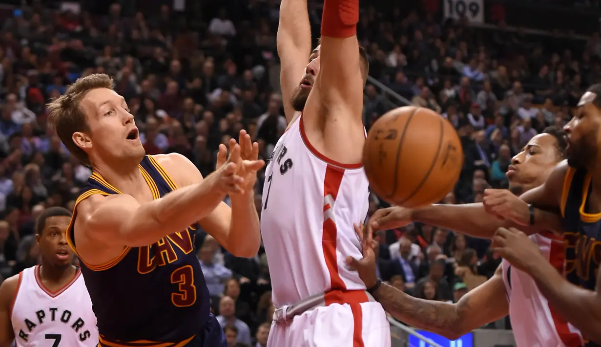 Pemain Cleveland Cavaliers, Mike Dunleavy #3 memberikan umpan kepada rekannya melewati hadangan Raptors, Jonas Valanciunas #17 pada laga NBA di Air Canada Centre, (6/12/2016). (Reuters/Dan Hamilton-USA TODAY Sports)