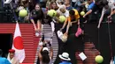 Petenis Jepang Naomi Osaka menandatangani benda yang disodorkan penonton usai mengalahkan petenis Republik Ceko Marie Bouzkova pada Australia Terbuka di Melbourne, Australia, Senin (20/1/2020). Penonton menyodorkan topi, bendera, hingga bola untuk ditandatangani Naomi. (AP Photo/Lee Jin-man)