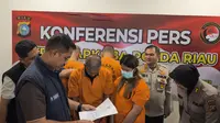 Pasangan suami istri yang ditangkap Polda Riau karena mengawal pengiriman sabu dan pil ekstasi bernilai belasan miliar ke Sumatra Selatan. (Liputan6.com/M Syukur)