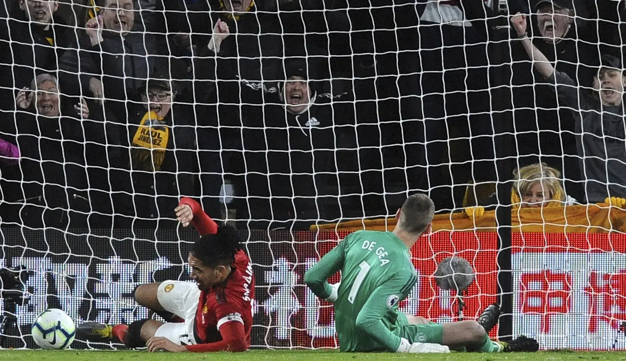 Bek Manchester United, Chris Smalling, melakukan gol bunuh diri saat melawan Wolverhampton Wanderers pada laga Premier League 2019 di Stadion Molineux, Selasa (2/4). Wolverhampton menang 2-1 atas Manchester United. (AP/Rui Vieira)