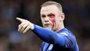 Striker Everton, Wayne Rooney, mengalami pendarahan di mata kirinya usai duel udara dengan bek Bournemouth, Simon Francis, pada Premier League, di Stadion Goodison Park, Sabtu (23/9/2017). Everton menang 2-1 atas Bournemouth. (AP/Barrington Coombs)