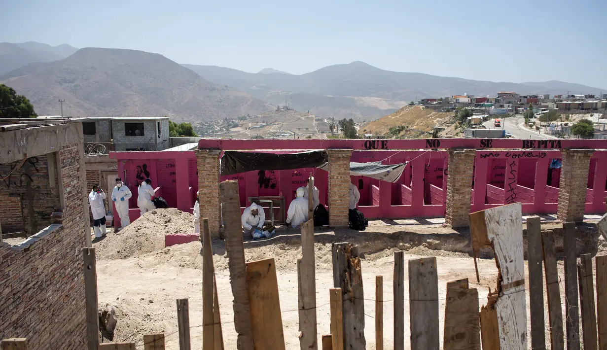 Tim forensik memeriksa sebuah kuburan massal yang ditemukan di Tijuana timur, Meksiko (17/8). Menurut pejabat setempat, lebih dari 600 fragmen tulang manusia ditemukan di perbatasan Meksiko-AS. (AFP Photo/Guillermo Arias)