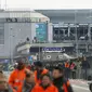 Calon penumpang berjalan meninggalkan lokasi ledakan di Bandara Zaventem dekat Brussels, Belgia, (22/3). Sedikitnya 13 orang tewas akibat ledakan beruntun yang mengguncang ruang keberangkatan bandara tersebut. (REUTERS / Francois Lenoir)