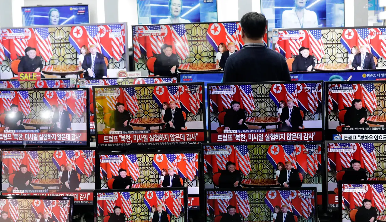 Seorang pria menyaksikan siaran langsung pertemuan Presiden AS Donald Trump dan pemimpin Korea Utara Kim Jong Un di Vietnam, di sebuah toko elektronik di Seoul, Korea Selatan (28/2). (AP Photo/Lee Jin-man)