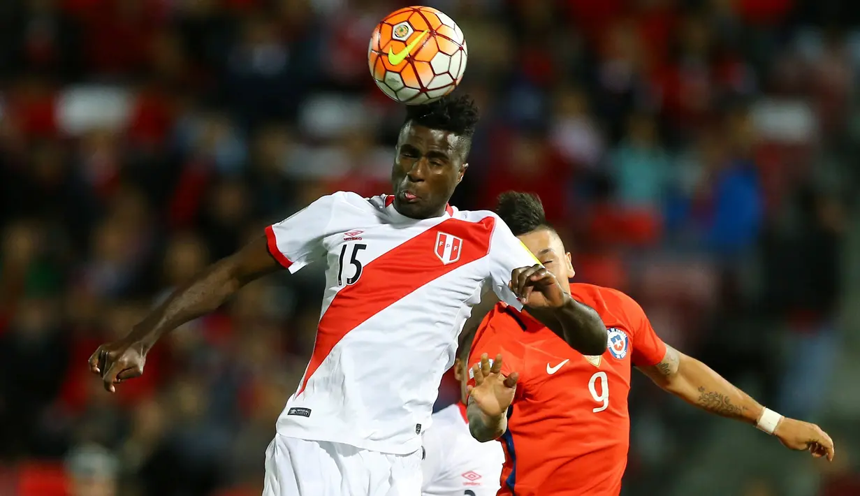 Bek Peru, Christian Ramos (depan) berebut bola udara dengan penyerang Chile, Nicolas Castillo pada Kualifikasi Piala Dunia 2018 di National Stadium, Santiago, Chile (11/10).  Chile menang atas Peru dengan skor 2-1. (REUTERS/Ivan Alvarado)