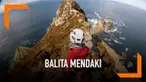 Seorang balita mendaki Tebing Sturall di Irlandia. Lokasi ini memiliki tinggi sekitar 200 meter dan dikenal menakutkan di Irlandia karena curam dan langsung berhadapan dengan laut lepas.