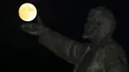 Supermoon terlihat di balik patung pendiri negara Soviet, Vladimir Lenin di Baikonur, Kazakhstan, (13/11). Fenomena ini merupakan bulan paling besar dan terang dalam kurun 70 tahun terakhir. (REUTERS/Shamil Zhumatov)