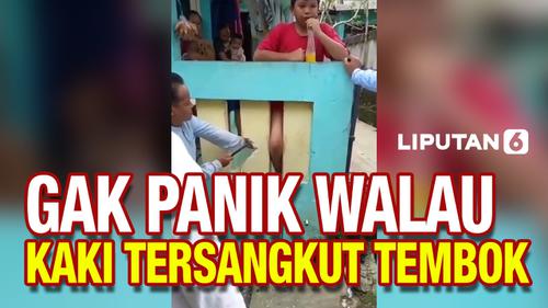 VIDEO: Kaki Tersangkut di Tembok Pagar, Bocah ini Asyik Seruput Minuman