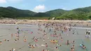 Orang-orang menikmati waktu senggang di sebuah resor pantai di Zhoushan, Provinsi Zhejiang, China timur (3/8/2020). Warga China menghabiskan waktu senggang dengan beraktivitas bermain air saat musim panas. (Xinhua/Yao Feng)