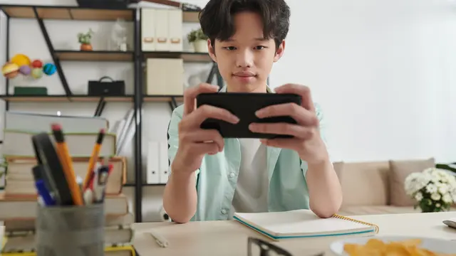 Seorang pria bermain gim mobile
