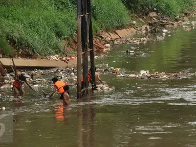 Petugas berusaha mengangkuti ceceran sampah di pinggir Kali Ciliwung di sisi jalan Menteng Tenggulun, Jakarta, Kamis (22/12). Turunnya debit air Kali Ciliwung membuat ceceran sampah tersangkut. (Liputan6.com/Helmi Fithriansyah)