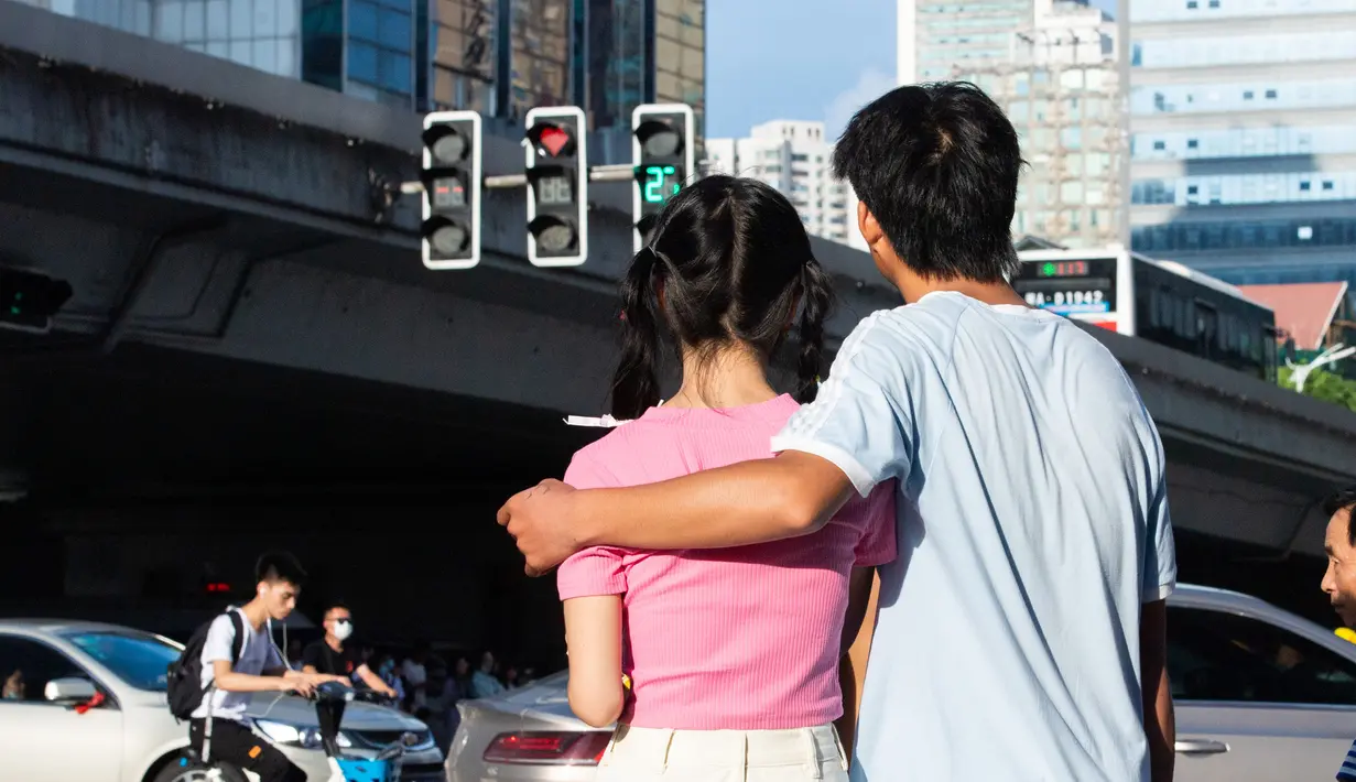 Dua sejoli memandangi lampu lalu lintas berbentuk hati di Changsha, Provinsi Hunan, China, 25 Agustus 2020. Festival Qixi, yang juga disebut sebagai Hari Valentine China, jatuh pada setiap hari ke-7 di bulan ke-7 menurut kalender bulan China. (Xinhua/Chen Sihan)