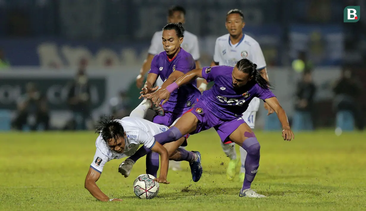 Dua pemain Persik Kediri, Rohit Chand (kanan) dan samsul Arifin berebut bola dengan pemain Arema FC, Jayus Hariono  dalam lanjutan pertandingan babak penyisihan Grup D Piala Presiden 2022 antara Persik Kediri menghadapi Arema FC di Stadion Kanjuruhan, Malang, Jawa Timur, Rabu (15/6/2022). (Bola.com/Arief Bagus)