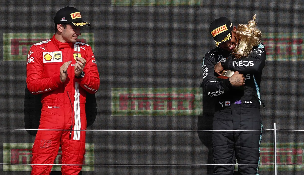 Pembalap Mercedes, Lewis Hamilton (kanan) berhasil meraih podium juara F1 GP Inggris, Minggu (18/7/2021) malam WIB. Sedangkan pembalap Ferrari Charles Leclerc menempati posisi kedua dalam balapan tersebut. (Foto: AFP/Adrian Dennis)