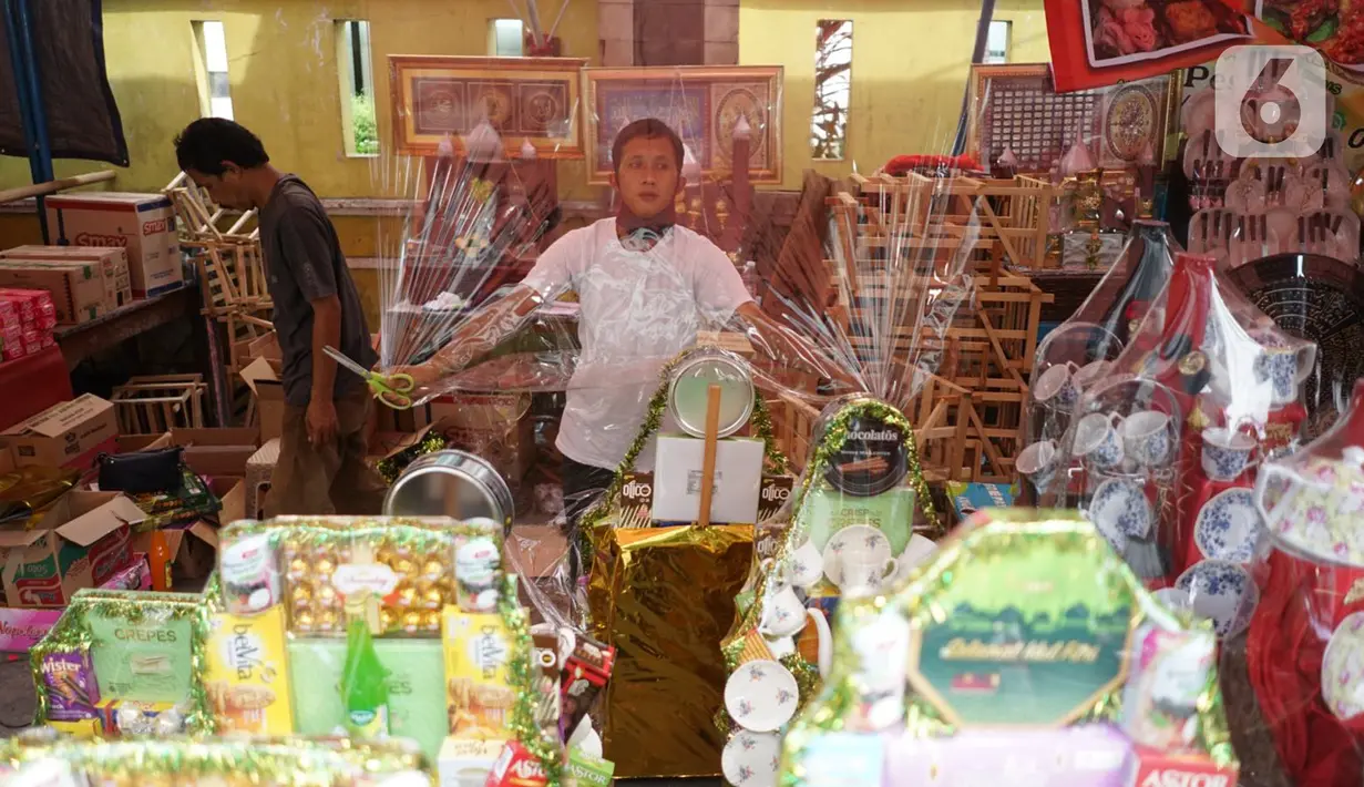 Pedagang menata dagangan di salah satu pusat penjualan parsel di kawasan Cikini, Jakarta, Rabu (13/5/2020). Selama bulan Ramadan, para pedagang mengaku omzet penjualan parsel turun hingga 90 persen dibandingkan tahun lalu akibat adanya pandemi virus corona COVID-19. (Liputan6.com/Immanuel Antonius)