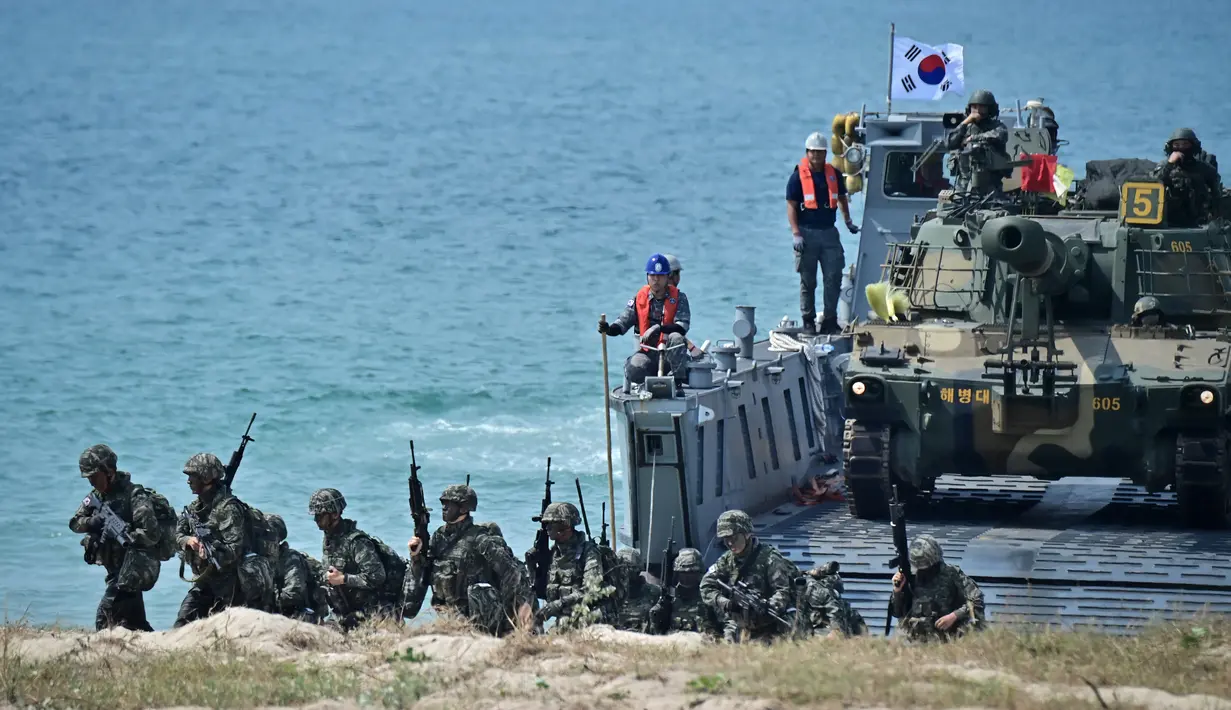 Marinir Korea Selatan mendarat untuk mengamankan pantai selama latihan pendaratan amfibi sebagai bagian dari latihan bersama Cobra Gold di pesisir provinsi Chonburi Thailand pada 3 Maret 2023. Cobra Gold tahun ini akan menjadi yang pertama melatih personel tentang bencana luar angkasa yang dapat membahayakan sistem komunikasi satelit. (AFP/Lillian Suwanrumpha)