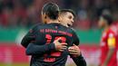 Cancelo pun tak dapat menutupi kebahagiannya dan langsung berpelukan Leroy Sane. (AP Photo/Michael Probst)