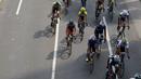 Para pebalap saat melewati ruas jalan protokol Sudirman pada ajang Tour de Jakarta di Bundaran Hotel Indonesia, Jakarta, Sabtu (30/7/2016). (Bola.com/Nicklas Hanoatubun)