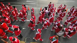 Peserta yang mengenakan kostum Sinterklas mengikuti lomba lari maraton dalam acara Santa Run 2019 di Goyang, Korea Selatan, Sabtu (7/12/2019). Sekitar 2.000 peserta berpartisipasi dalam lomba marathon lari 5 kilometer dan 10 kilometer. (Jung Yeon-je/AFP)