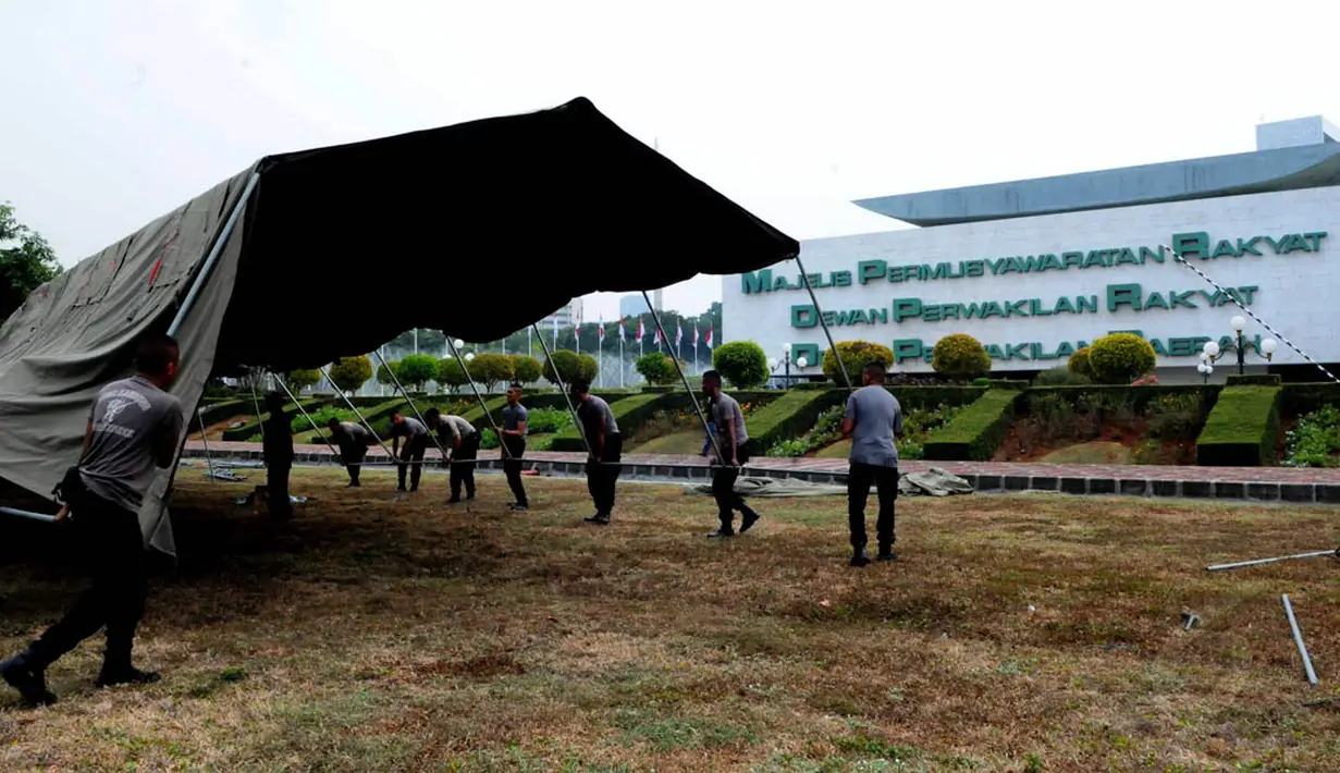 Anggota Kepolisian mendirikan tenda di halaman kompleks Gedung MPR/DPR/DPD, Senayan, Jakarta, (15/10/14). (Liputan6.com/Andrian M Tunay)