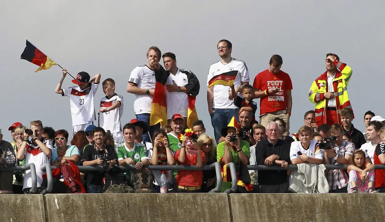 Di salah satu jembatan, puluhan suporter Timnas Jerman menanti kedatangan tim asuhan Joachim Loew di Bandara Tegel, Berlin, (15/7/2014). (REUTERS/Karina Hessland/Pool)