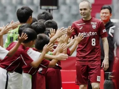 Andre Iniesta disambut anak-anak saat perkenalan bersama klub barunya, Vissel Kobe di NOEVIR Stadium Kobe, Kobe, (26/5/2018). Iniesta dikontrak Vissel Kobe selama tiga tahun. (Michi Ono/Kyodo News via AP)