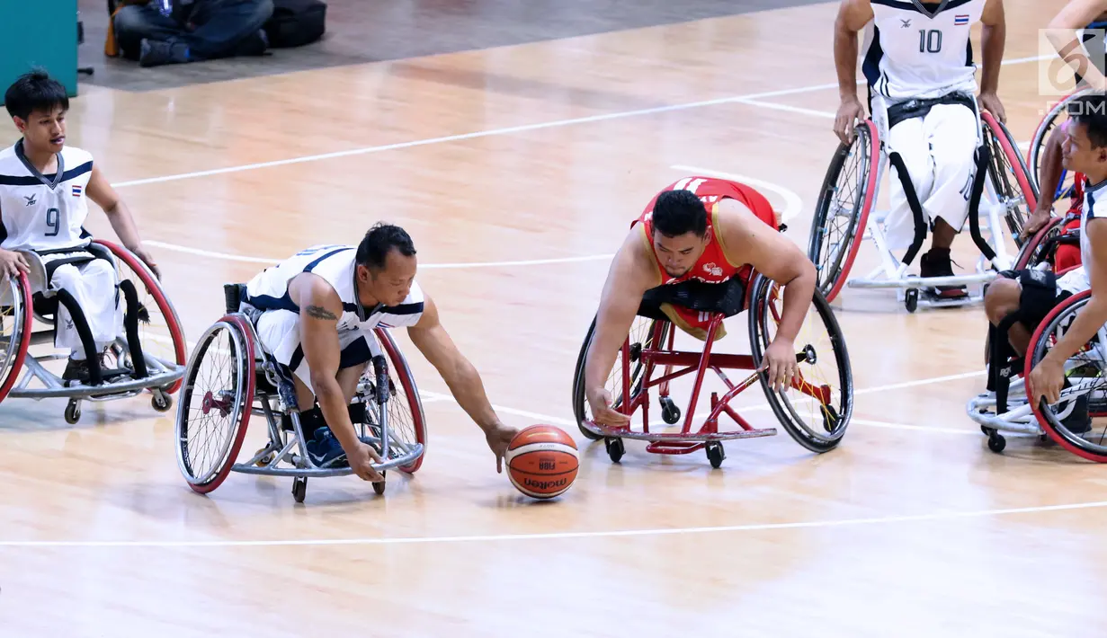 Pebasket difabel Indonesia, Kasep Ayatulloh berebut bola dengan pemain Thailand pada laga Indonesia Para Games Invitational Tournament 2018 di Hall A GBK, Jakarta, Senin (2/7). Indonesia kalah 35-58. (Liputan6.com/Helmi Fithriansyah)