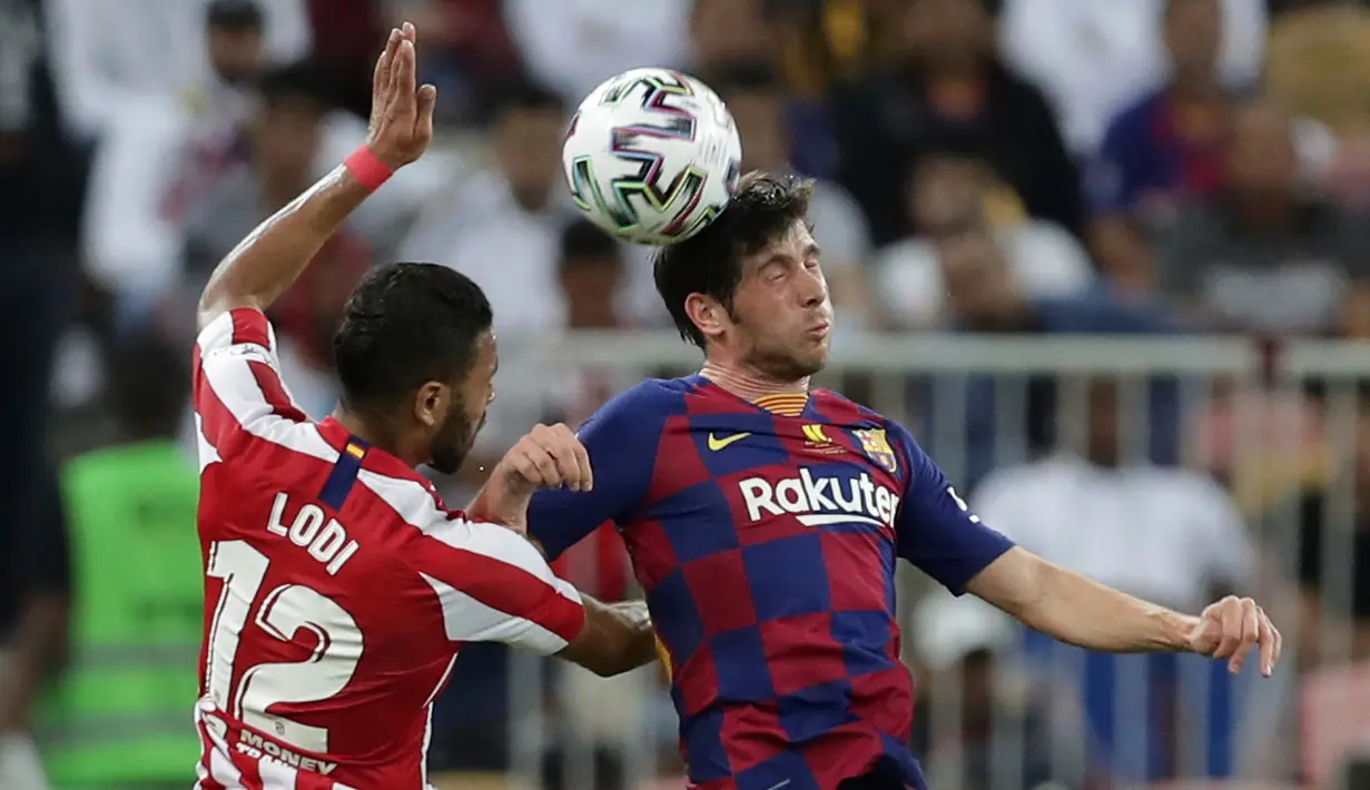 Pemain Atletico Madrid Renan Lodi berebut bola dengan bek Barcelona Sergi Roberto, pada laga semifinal Piala Super Spanyol di King Abdullah Sports City, Jeddah, Kamis (9/1/2020). Barcelona harus menjalani pertandingan yang dramatis saat kalah 2-3 dari Atletico Madrid. (AP/Hassan Ammar)