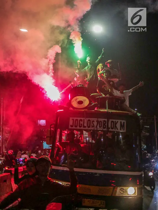 Warga konvoi menggunakan bus saat merayakan malam takbiran menyambut Hari Raya Idul Fitri 2019 di kawasan Tanah Abang, Jakarta, Selasa (4/6/2019). Pemerintah menetapkan Hari Raya Idul Fitri 1440 Hijriah jatuh pada hari Rabu 5 Juni 2019. (Liputan6.com/Faizal Fanani)