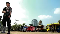 Seorang polisi berjaga ditempat penukaran uang receh di Monas, Jakarta, Selasa (30/6/2015). Bank Indonesia bekerjasama dengan 14 bank lainnya membuka loket penukaran uang pecahan kecil sejak 17 Juni-15 Juli 2015. (Liputan6.com/Faizal Fanani)