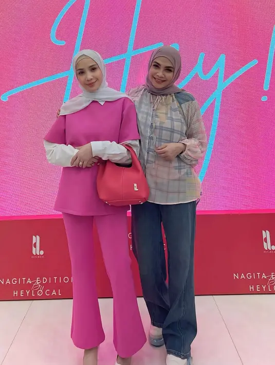 Nagita Slavina padukan kemeja putih lengan panjang berlapis setelan A-line top dan celana cut bray pink [@rieta_amalia]