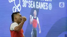 Lifter Eko Yuli usai melakukan angkatan saat SEA Games 2019 cabang angkat besi nomor 61 kg di Stadion Rizal Memorial, Manila, Filipina, Minggu (1/12/2019). Dirinya meraih emas dengan total angkatan 309 kg. (Bola.com/M Iqbal Ichsan)