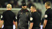 Pelatih Liverpool, Jurgen Klopp berjalan menghampiri para wasit usai pertandingan melawan West Ham United pada lanjutan Liga Inggris di The London Stadium (4/2). Liverpool bermain imbang 1-1 atas West Ham. (AFP Photo/Glyn Kirk)