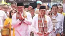 Pasangan bakal calon gubernur dan wakil gubernur DKI Jakarta Ridwan Kamil dan Suswono saat tiba di halaman kantor Komisi Pemilihan Umum (KPU) Provinsi DKI Jakarta, Jalan Salemba Raya, Jakarta, Rabu (28/8/2024). (Liputan6.com/Angga Yuniar)