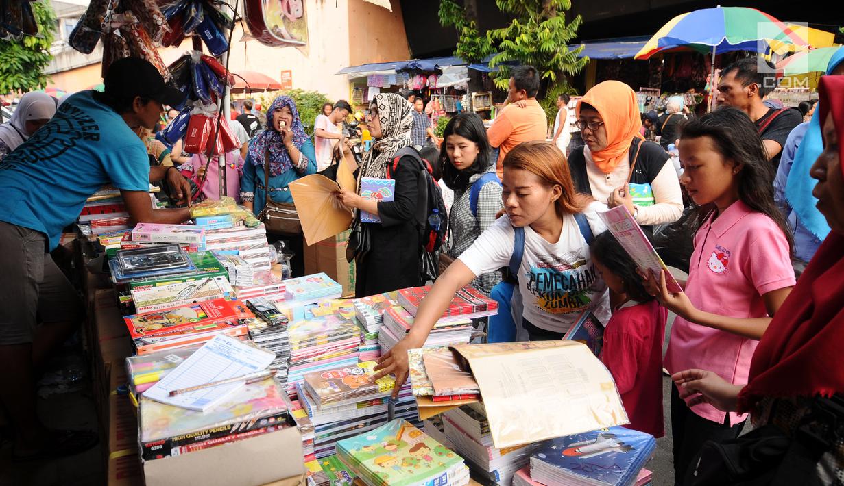 Warga memilih buku tulis yang dijajakan pedagang di sekitar Pasar Asemka, Jakarta, Rabu (5/7). Jelang bergantinya tahun ajaran baru, sejumlah warga berburu peralatan sekolah di kawasan Pasar Asemka Jakarta. (Liputan6.com/Helmi Fithriansyah)