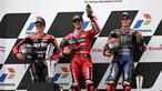 Pembalap Ducati Lenovo Team, Francesco Bagnaia (tengah), bersama pembalap Aprilia Racing, Maverick Vinales (kiri) dan pembalap Monster Energy Yamaha, Fabio Quartararo, berhasil meraih podium juara MotoGP Mandalika 2023 setelah menjalani balapan di Mandalika International Street Circuit, Lombok, Minggu (15/10/2023) siang WIB. (AFP/Sonny Tumbelaka)