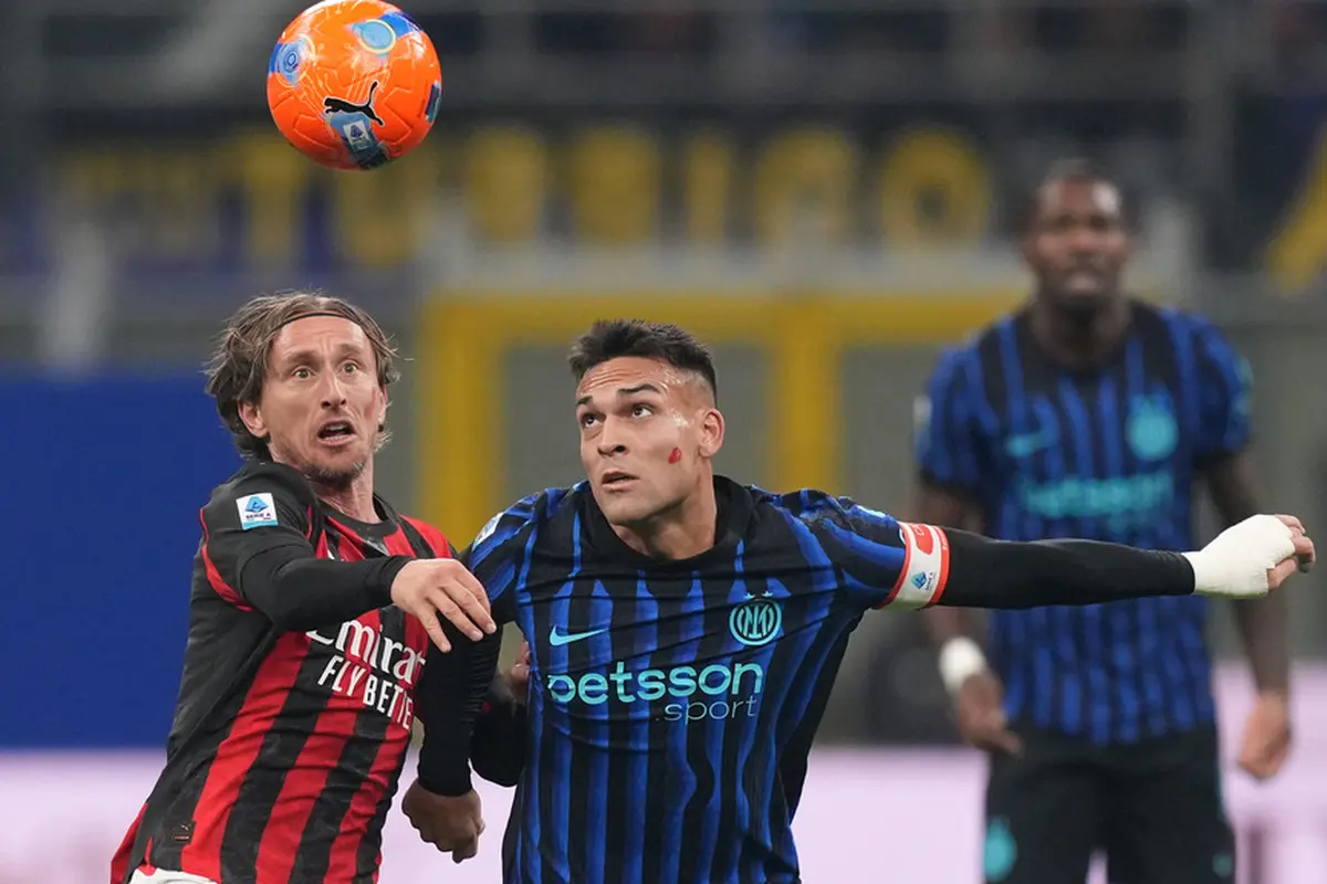 Luka Modric dari AC Milan (kiri) berebut bola dengan Lautaro Martinez dari Inter Milan