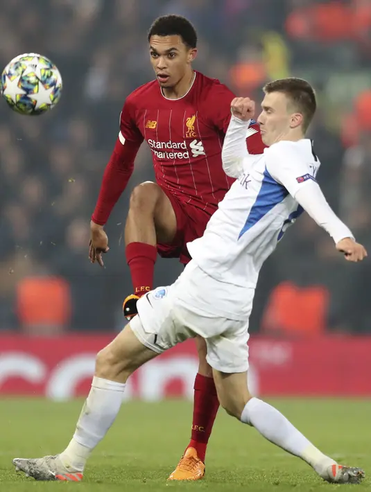 Bek Liverpool, Trent Alexander-Arnold berebut bola dengan gelandang KRC Genk, Bryan Heynen pada pertandingan lanjutan Grup E Liga Champions di Stadion Anfield, Inggris (5/11/2019). Liverpool menang tipis 2-1 atas Genk. (AP Photo/Jon Super)