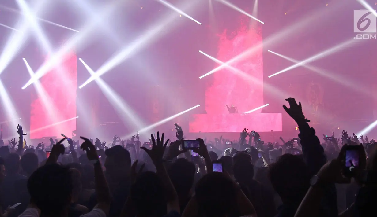 Para pengunjung menyaksikan DJ Alan Walker di Invasion 2017 di Jakarta, Jumat (22/9). DJ asal Norwegia tersebut menampilkan sejumlah lagu miliknya diantaranya Faded, Sing Me To Sleep dan Alone. (Liputan6.com/Herman Zakharia)