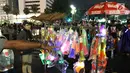 Pedagang menjual terompet pada malam pergantian tahun di kawasan Bundaran HI, Jakarta, Senin (31/12). Pergantian tahun dimanfaatkan pedagang untuk mencari keuntungan dengan berjualan pernak pernik tahun baru.(Liputan6.com/Angga Yuniar)