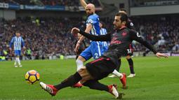 Aksi pemain Arsenal, Henrikh Mkhitaryan melepaskan umpan saat melawan Brighton pada laga Premier League di American Express Community Stadium, Brighton, (4/3//2018). Arsenal kalah 1-2. (AFP/Glyn Kirk)