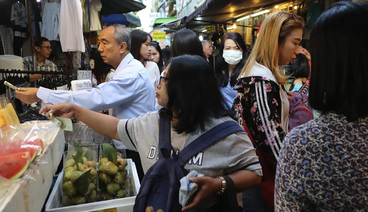 Sejumlah pembeli membeli makanan di gang, yang terkenal dengan pedagang kaki lima dan pakaian, sebelum mereka pergi bekerja di pusat kota Bangkok, Thailand (8/11/2019). (AP Photo/Aijaz Rahi)