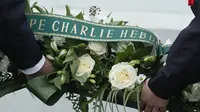 Peringatan tiga tahun tragedi Charlie Hebdo. (AP Photo/ Christian Hartmann)