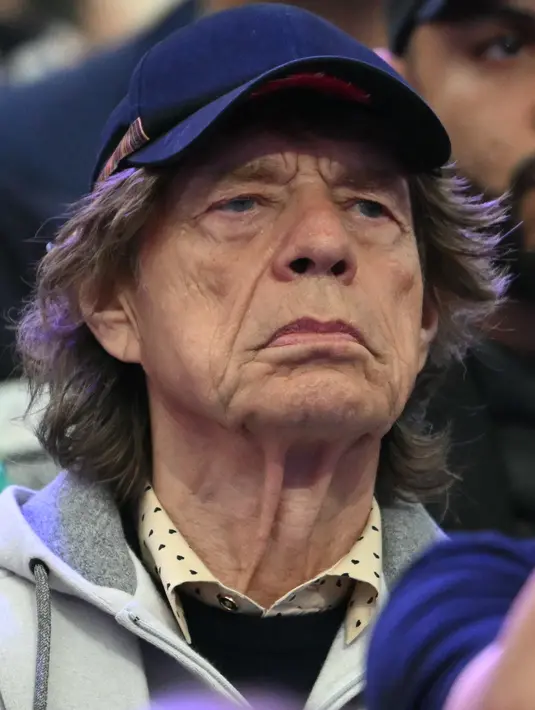 Rocker Rolling Stones ini mengenakan pakaian sederhana dengan hoodie resleting di atas kemeja jumper dengan motif polkadot. (Fabrice COFFRINI / AFP)